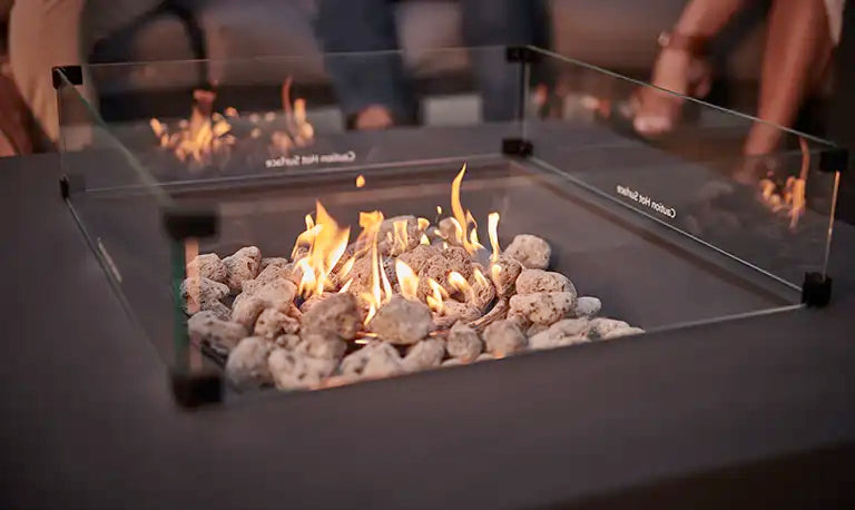 Close up of flames on a fire pit table in the garden