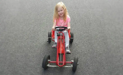 Girl playing on a 40 year old Kettler Go-Kart.