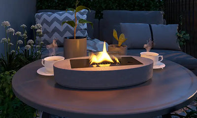 Embracing hugge with a tenderflame candle lit on a garden coffee table in the evening