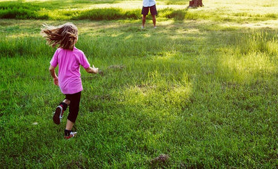 young girl running in garden