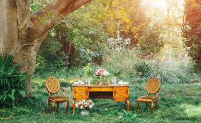 Chairs and desk situated in wildflower garden.