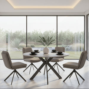 Modern dining room with the Boston Round Dining table and 4 Dining chairs near large windows with a view of greenery.