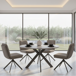 Modern dining room with the Boston Round Dining table and 4 Dining chairs near large windows with a view of greenery.