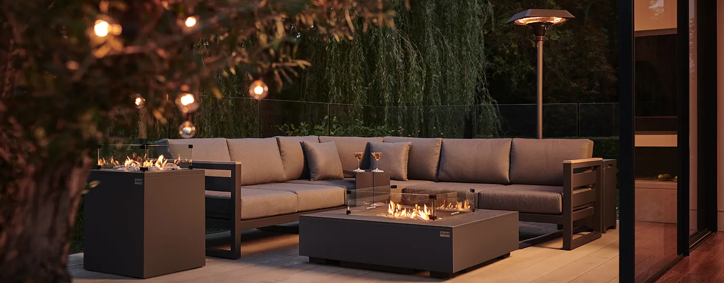 Outdoor fire pit surrounded by sofas