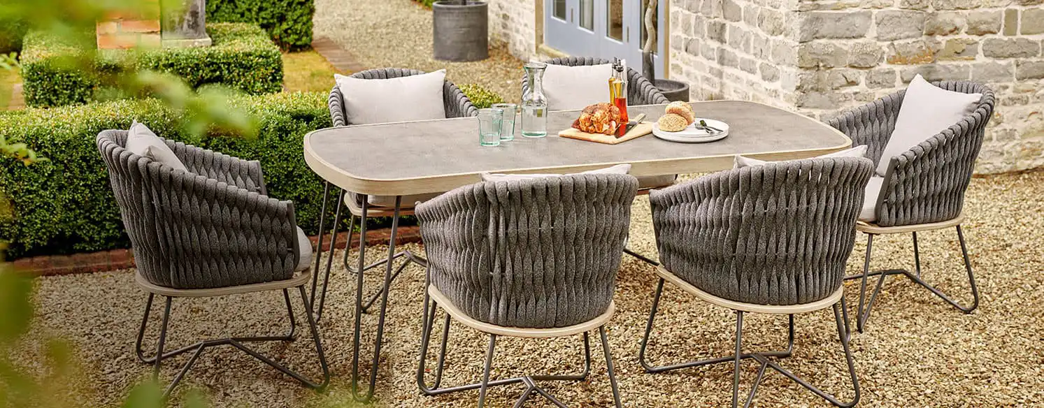 Six chairs around a dining table in the garden