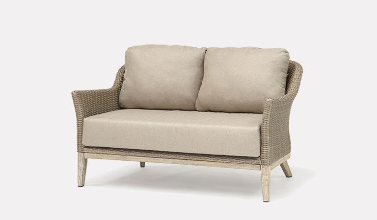 The Cora 2 Seater Sofa from KETTLER's garden furniture range on a grey background.