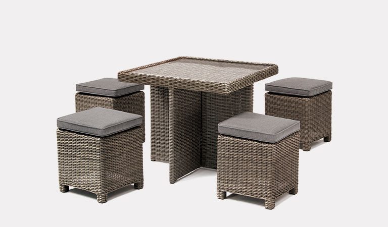 Cube Set with Glass Top Table in rattan from KETTLER's Casual Dining garden furniture range on a grey background.