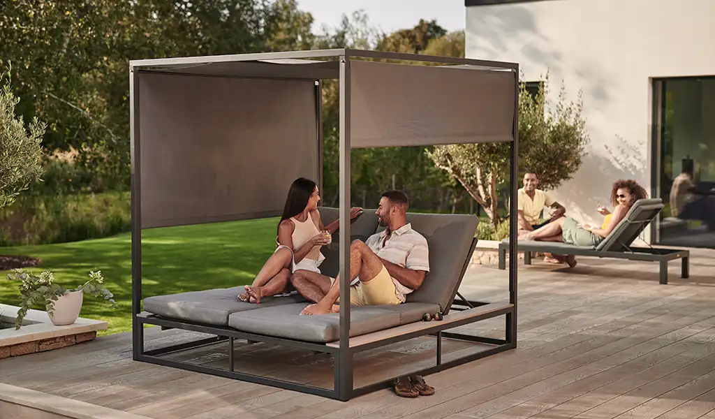 elba day bed in garden with couple relaxing