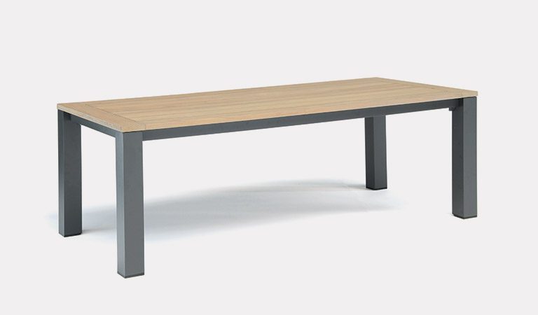 The Elba Dining Table on a grey background.