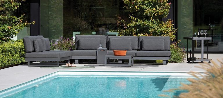 The Bari-Lite Lounge garden furniture with the Bari Side Table, from the Jati & Kebon range, on a patio.