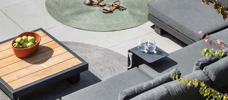 The Bari-Lite Side Table, from the Jati & Kebon range, on a patio.