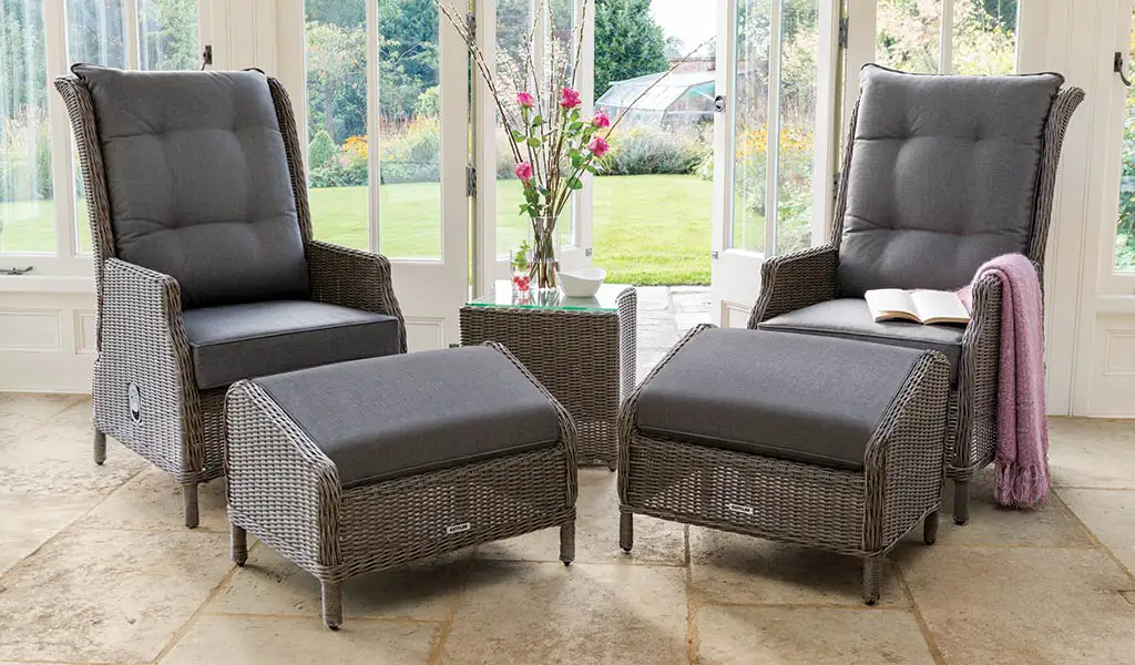 Classic Recliner with Footstool from Kettler wicker garden furniture in a conservatory.