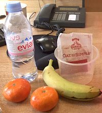 Bottle of water, fruit and porridge