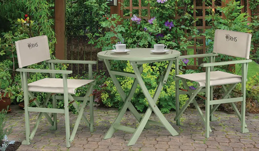2 RHS By Kettler Rosemoor Director's Chairs with a Rosemoor Bistro Table on a patio.