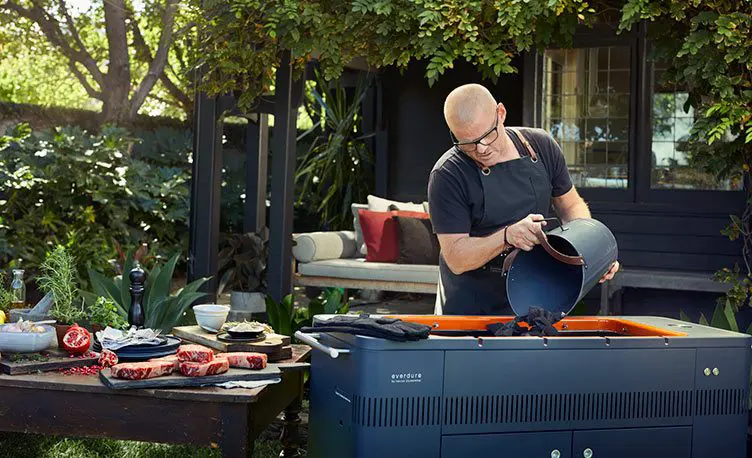 heston blumenthaul tipping charcoal on to bbq