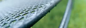 Close up of classic mesh furniture in the rain