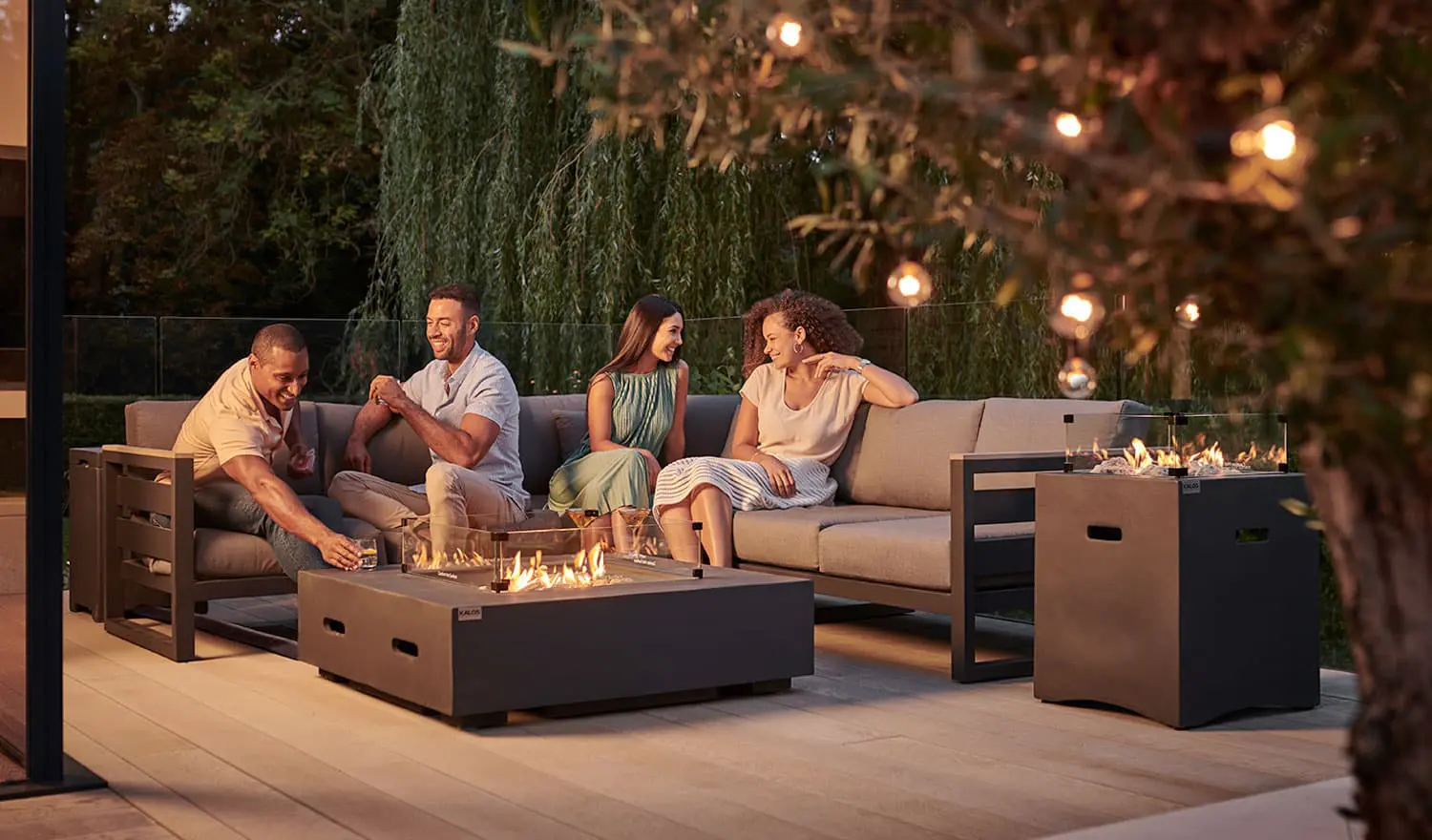 casual dining set with fire pit on patio at night