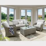 Charlbury lounge set in a brightly lit conservatory with garden in the background