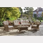 RHS Harlow Carr lounge set with 3 seater sofa on a garden patio with flowers