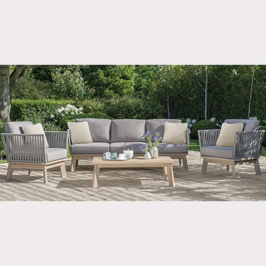 Adelaide Lounge Set comprising of two armchairs 3 seater sofa and coffee table on garden decking in the sunshine