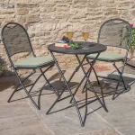 Café Roma bistro set with sage cushions on a garden patio in the sun shine