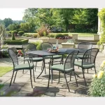 6 seater Caredo chair dining set in classic metal mesh on a garden patio in the sunshine