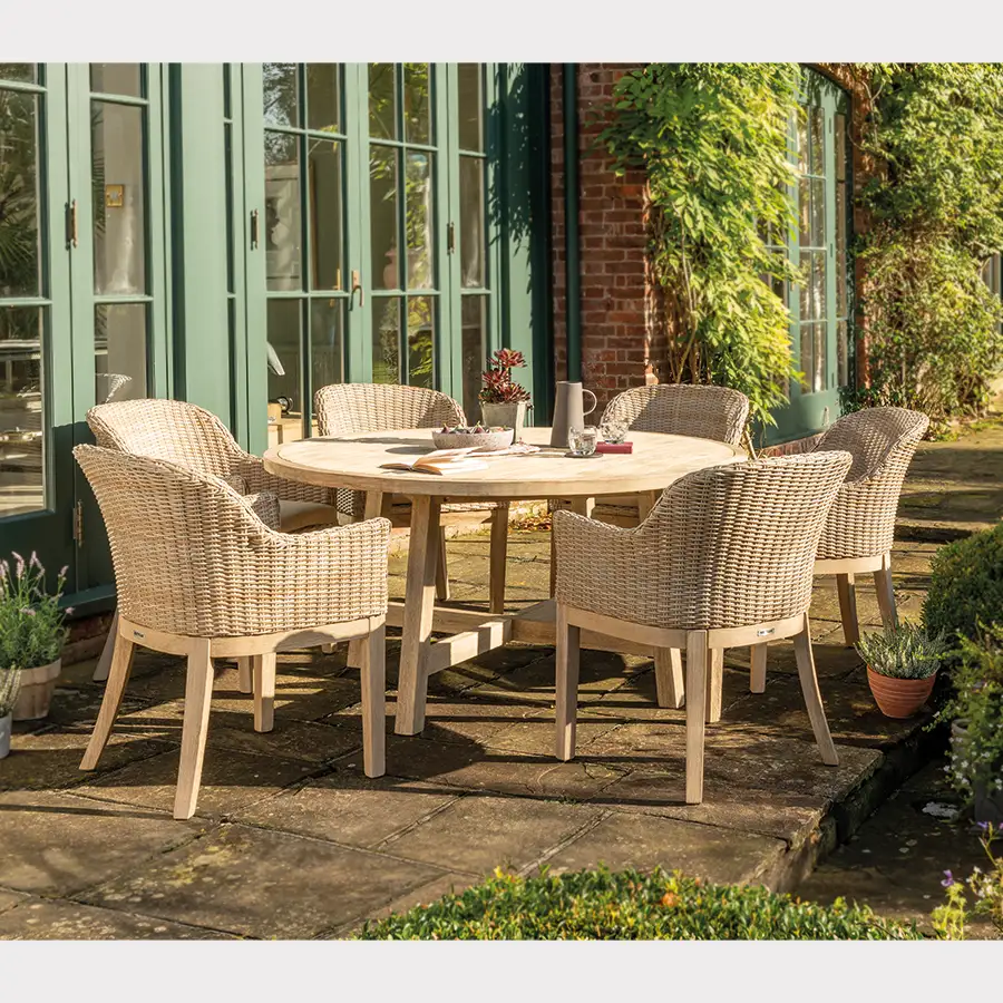 Cora wicker 6 seat dining set made from fsc wood on a garden terrace in the sunshine