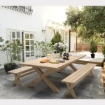 Cora dining bench set for 8 people with 280 x 110cm crossed leg wooden dining table on a on a garden terrace