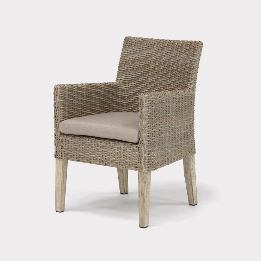 Cora wicker dining armchair made from fsc wood on a plain white background