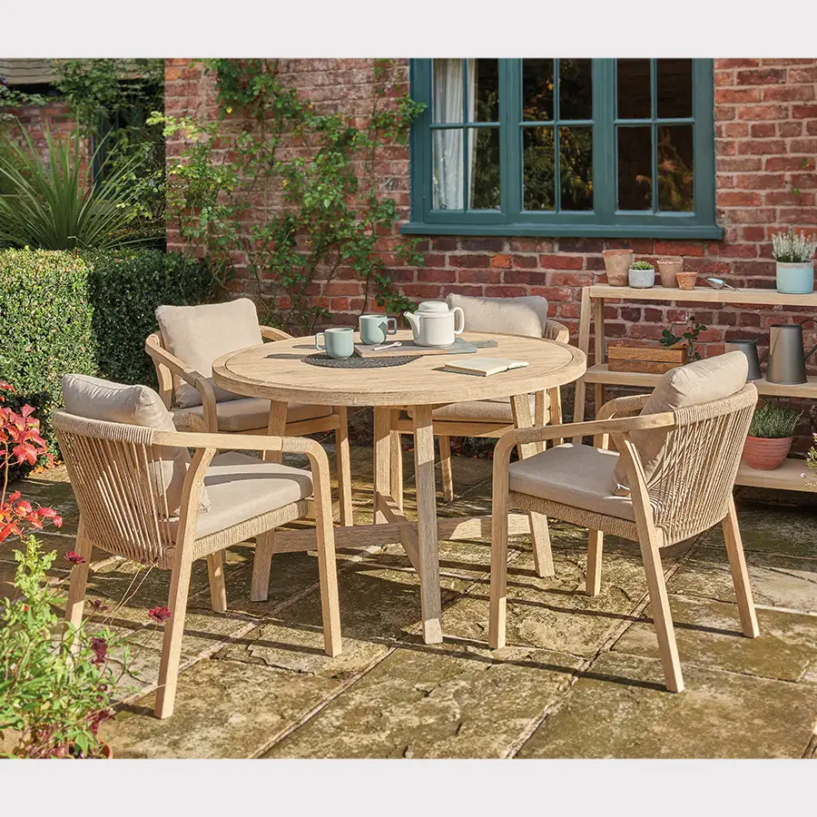 Cora rope dining set with 4 chairs and a round 120cm dining table on a garden terrace in the sunshine