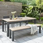 6 seat elba dining set with bench and 3 chairs in grey on a garden patio in the sun shine
