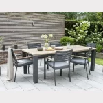 6 seat elbal dining set in grey on a garden patio in the sun shine