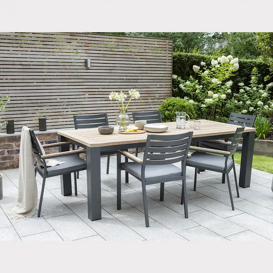 6 seat elbal dining set in grey on a garden patio in the sun shine