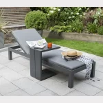 Elba lounger in grey with back rasied and side table on a garden patio