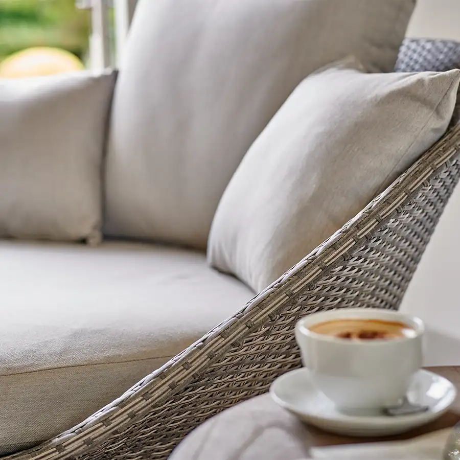 Detail image of cushions on a LaMode comfort chair with cup coffee to the side