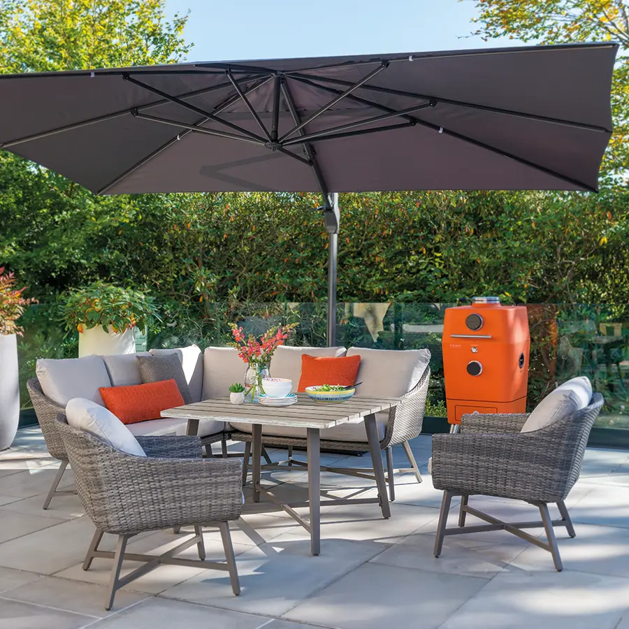 Lamode corner lounge set on a modern patio under a large 4m parasol with everdure 4k bbq