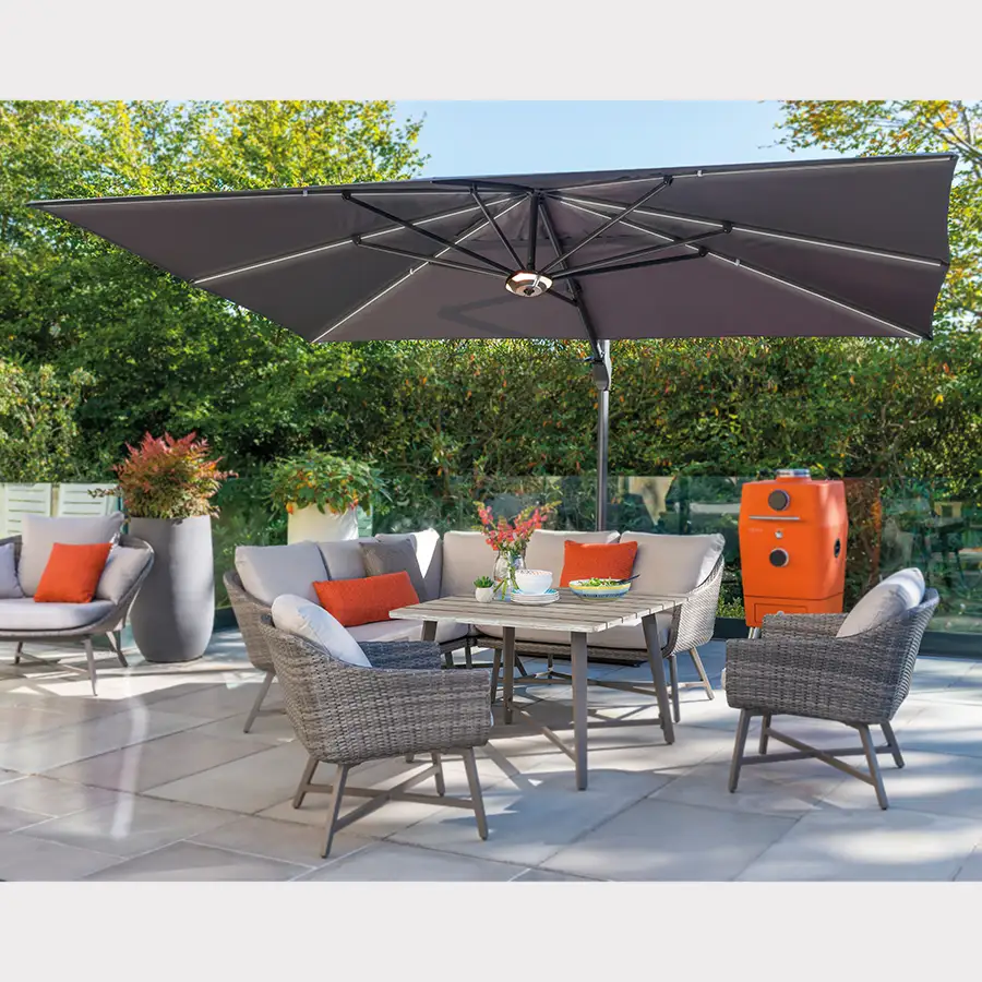 Large free arm parasol set up over lamode corner set and 4k BBQ on garden patio