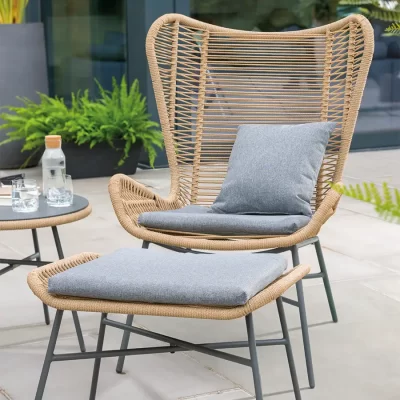 Lyon Lounge Chair and footstool on a garden patio in the sun shine