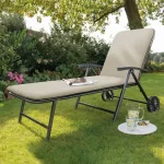 Novero Lounger with stone cushion on grass in the garden