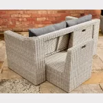 Palma compact corner sofa in white wash wicker with grey cushions showing how chairs store in the back
