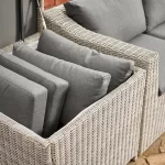 Palma compact corner sofa in white wash wicker with grey cushions shows cushions stored in the storage box