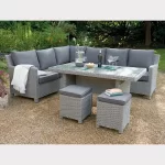 Palma wicker corner set with glass top table with wine glasses on a patio