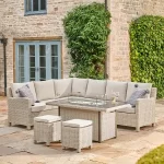 Wicker corner dining set with fire pit table on a patio in summer