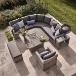 Airial view of Palma Grande casual dining corner sofa set in white wash with grey cushions in the garden