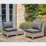 Palma Low Lounge companion set in white wash wicker with grey cushions on garden patio