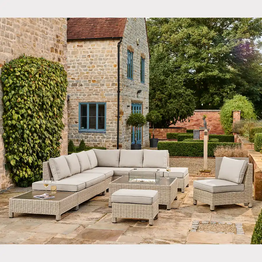 Oyster palma low lounge set with fire pit table on a garden patio