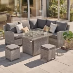 Palma mini fire pit table in white wash with aluminiun slats on a modern garden patio with luxury home behind