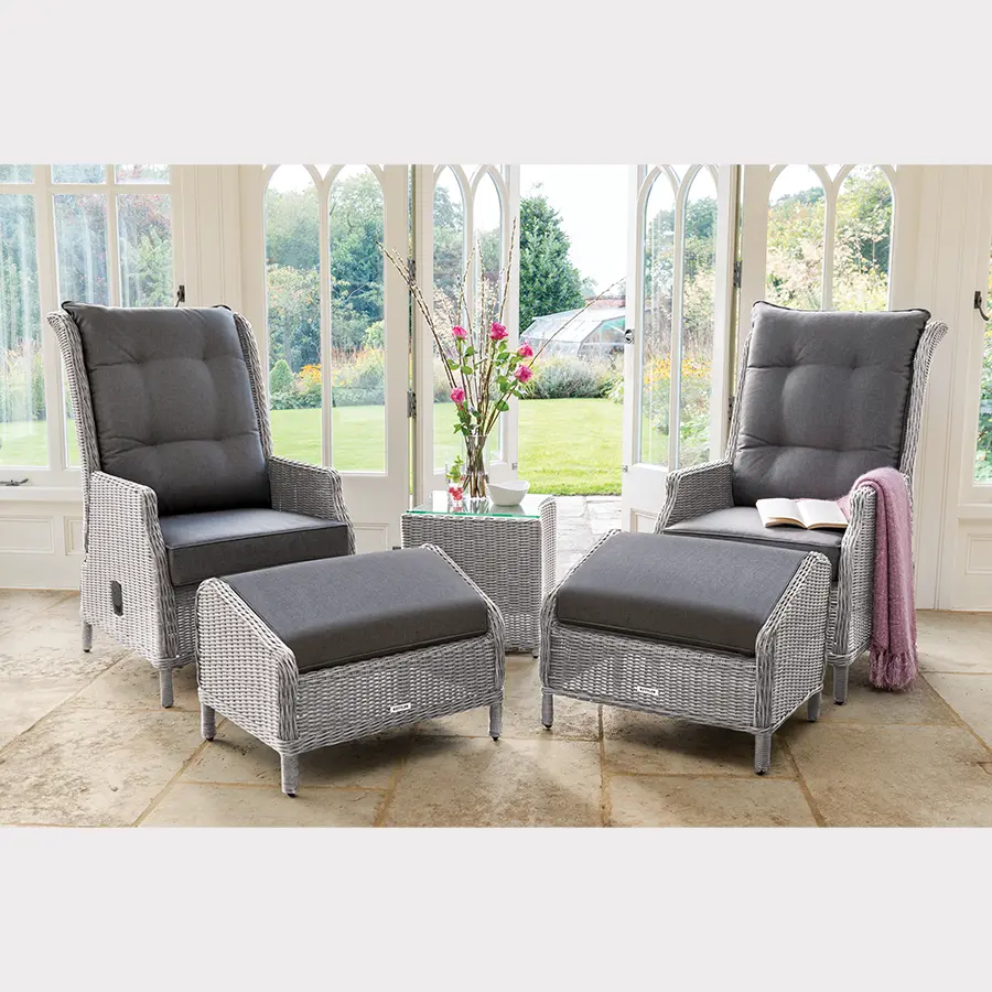 Pair of white wash Palma recliners with foot stools in a conservatory setting