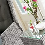 Palma wicker side table with glass top in white wash in a conservatory setting