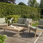 RHS Hampton lounge set with 2 seater sofa on a garden decking with hedge